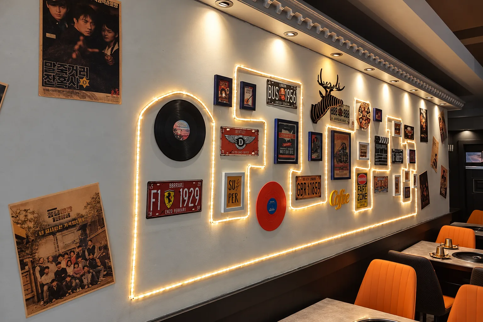 Wall decorated with posters and plates, orange chairs